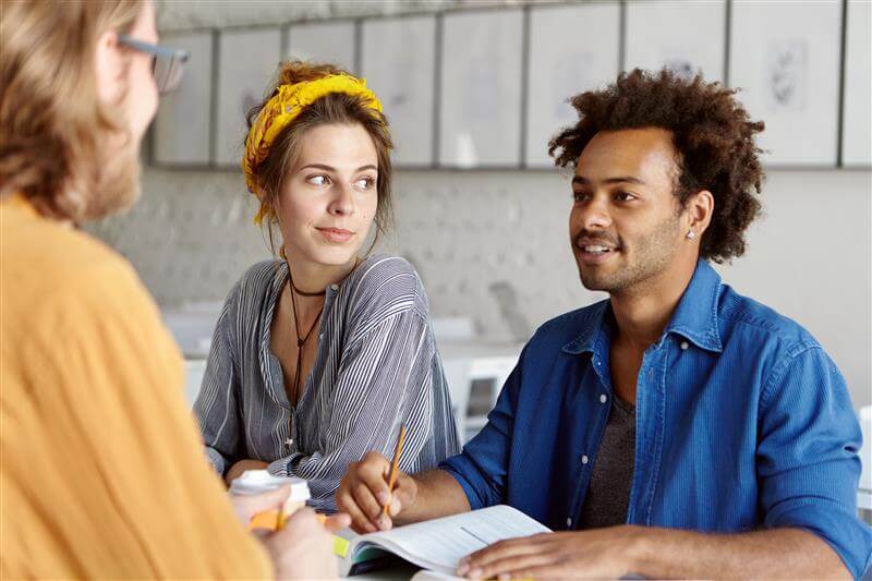people sat round talking at a table