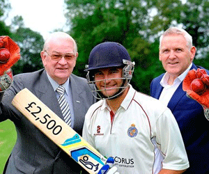 Cricketer posing with bat