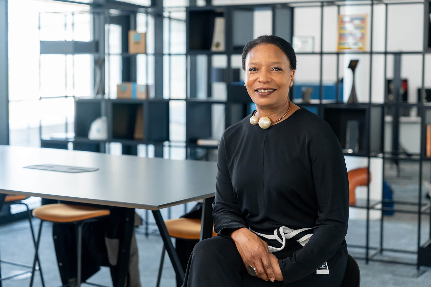 Smartly dressed woman sat in an office