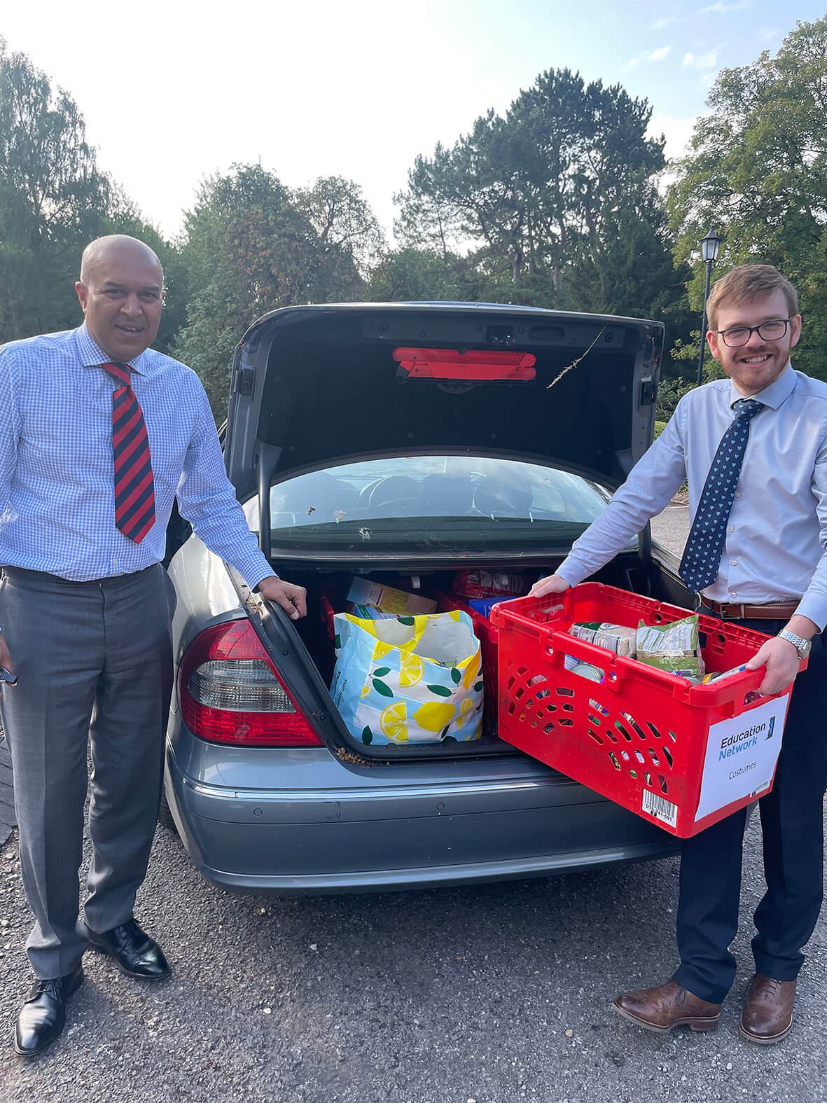 Manny Rai and Harry Chase load the car with hampers for families in need