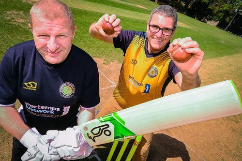 Cricketers posing with bats