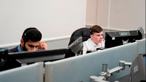 Young workers behind desktop computers