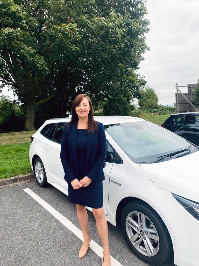 Person stood by an electric vehicle