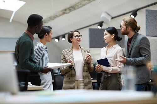 Group of employees chatting in an office