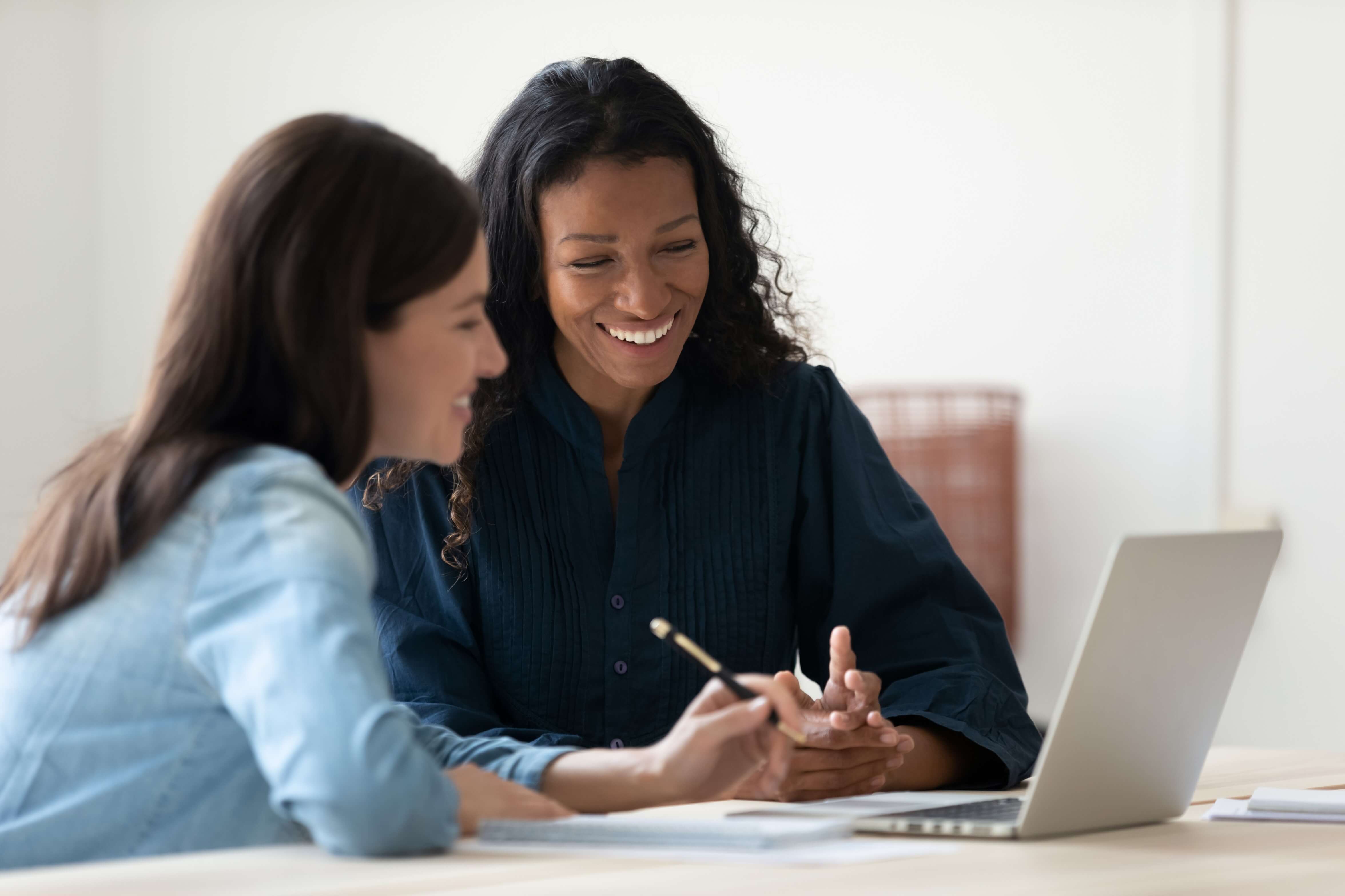 Two women using a laptop